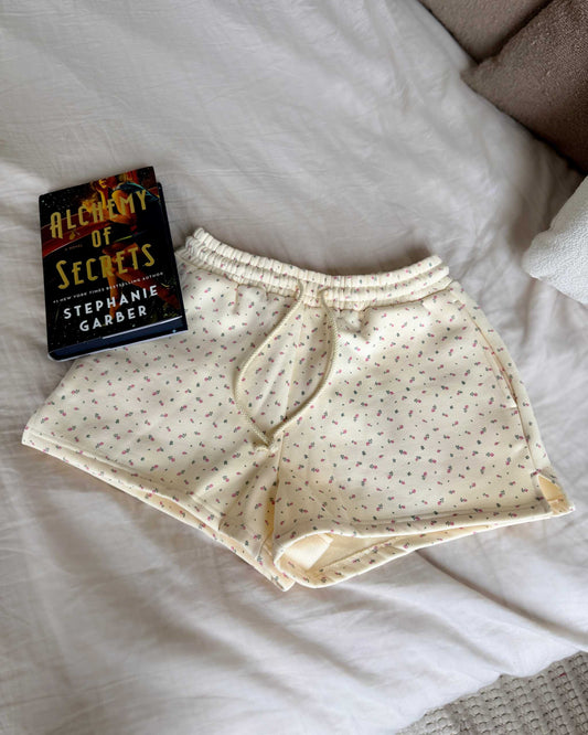 The Floral Sweat Shorts from Next Chapter are butter yellow with a feminine floral fabric detailing.