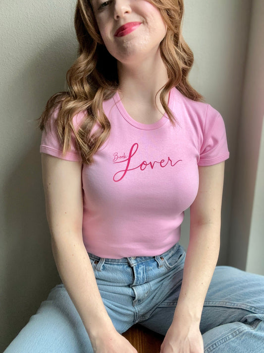 pink ribbed cotton Book Lover Baby Tee with red text worn by model