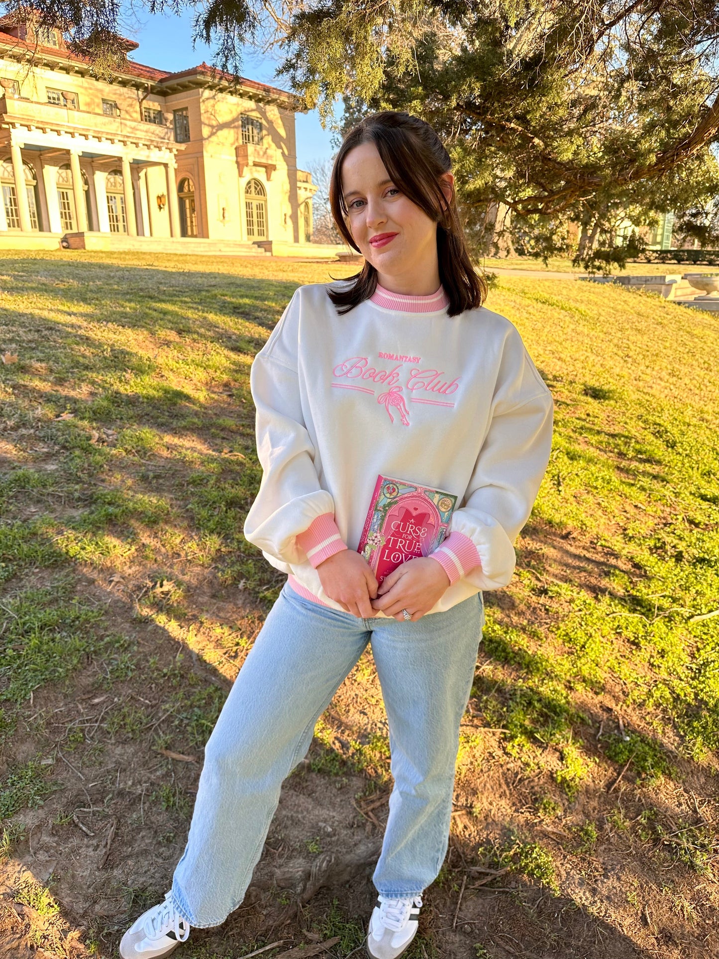 Romantasy Book Club Crewneck. Embroidered sweatshirt with a stylish pink trim collar and sleeves. Book merch for lovers of the romance and fantasy bookish genres.