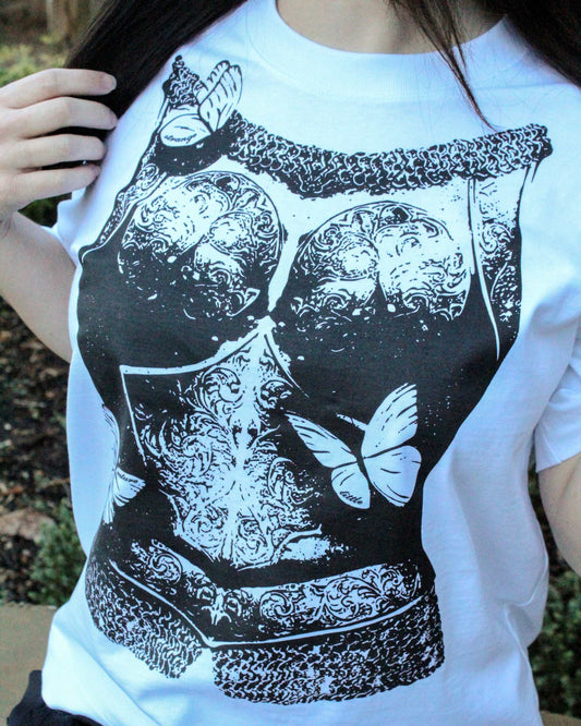 The Diviner in Shining Armor Tee, white cotton with bold black medieval armor artwork and moth details.