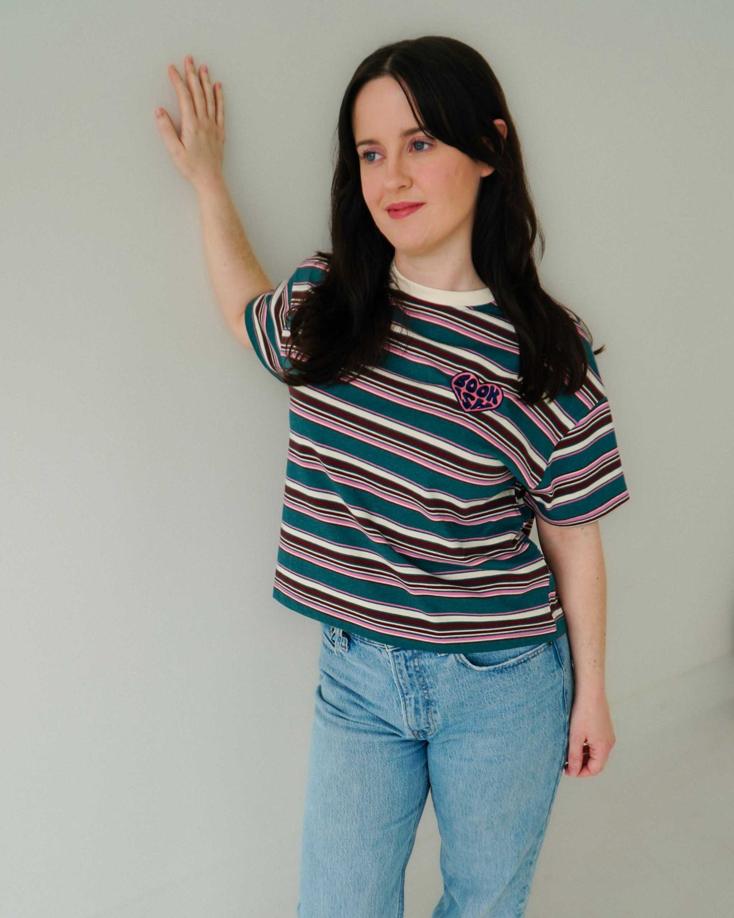 The Bookish Retro Boxy Tee with stripes and an embroidered design from Next Chapter Bookwear, a high quality bookish apparel shop.