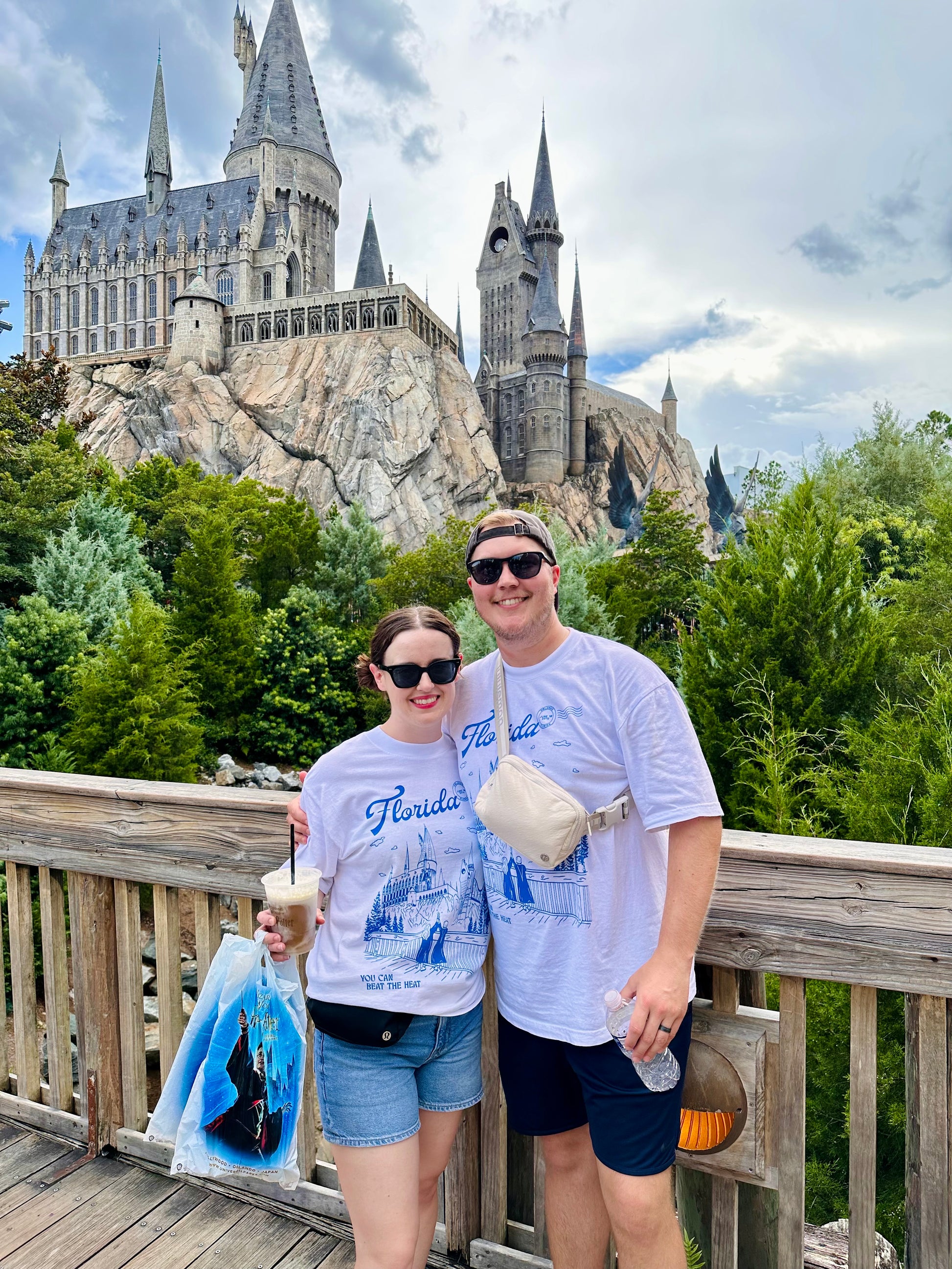 Two people at the Wizarding World of Harry Potter wear a t-shirt that depicts the theme park. The t-shirt also references Taylor Swift's song "Florida!!!" 