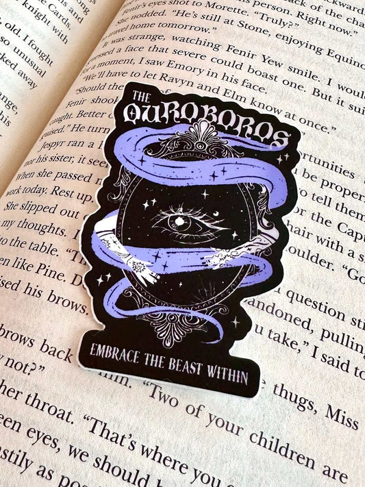 Ouroboros Acotar Sticker featuring a purple ouroboros snake around an eye with "Embrace the beast within" text on a book background