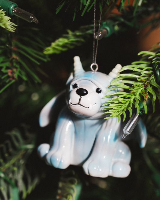 Bartholomew Gargoyle Ornament with a glossy pale blue body, white face, black eyes, small horns, and silver hanging loop. Officially licensed Rachel Gillig merch.