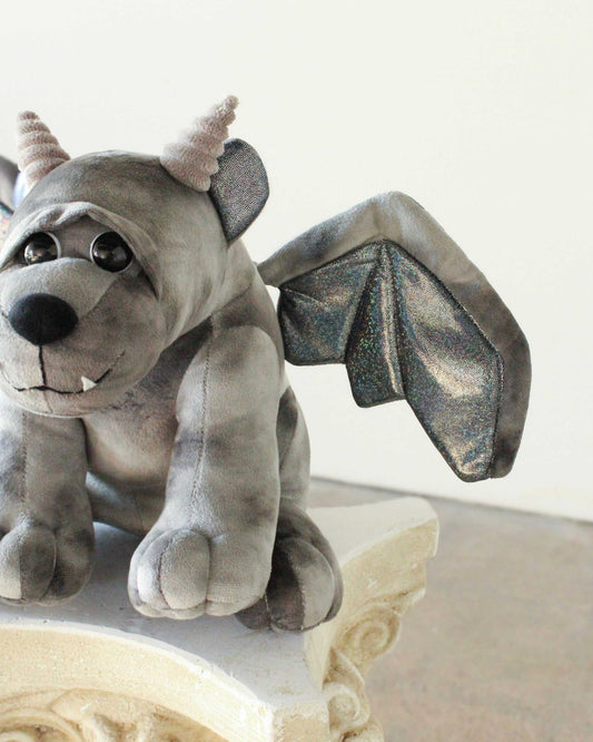 Bartholomew Gargoyle plush in soft gray fabric with small horns, a toothy smile and sparkly bat wings