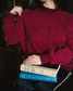 The Reader Mock Neck sweatshirt from Next Chapter is a beautiful berry, dark magenta color with an embroidered 'reader' design across the front. It's the perfect cozy bookish sweater for readers and book lovers.