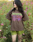 A woman wearing the Sweetwater Peak Tee from Next Chapter, inspired by the book Free Falling by Lyla Sage