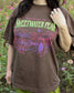 A woman wearing the Sweetwater Peak Tee from Next Chapter, inspired by the book Free Falling by Lyla Sage