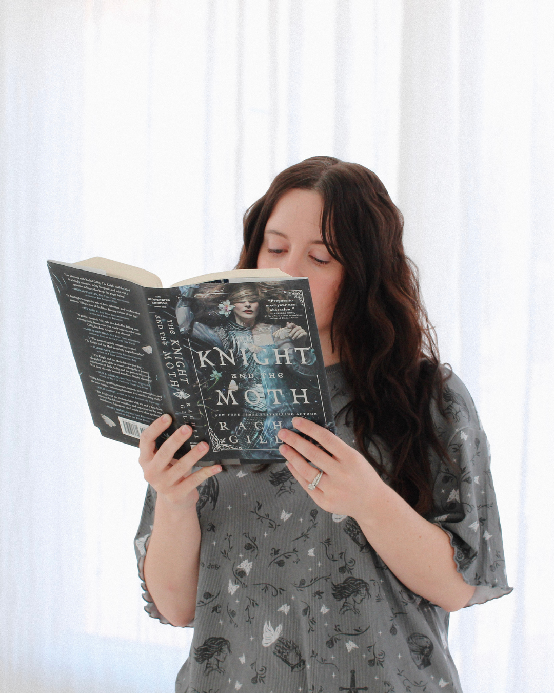 A woman wearing the knight and the moth lounge set from Next Chapter. This is a cozy bookish pajama set for fantasy book lovers, inspired by The Knight and the Moth.