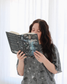 A woman wearing the knight and the moth lounge set from Next Chapter. This is a cozy bookish pajama set for fantasy book lovers, inspired by The Knight and the Moth.